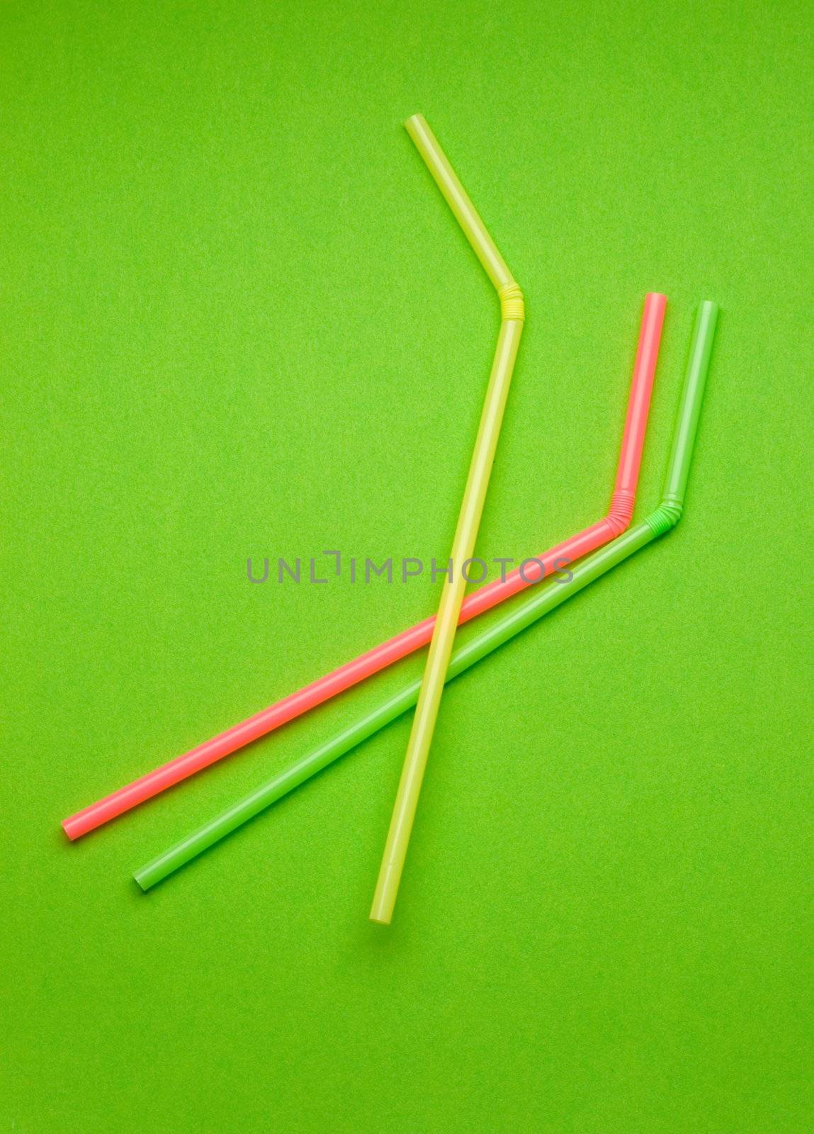 Straws isolated on green by Garsya