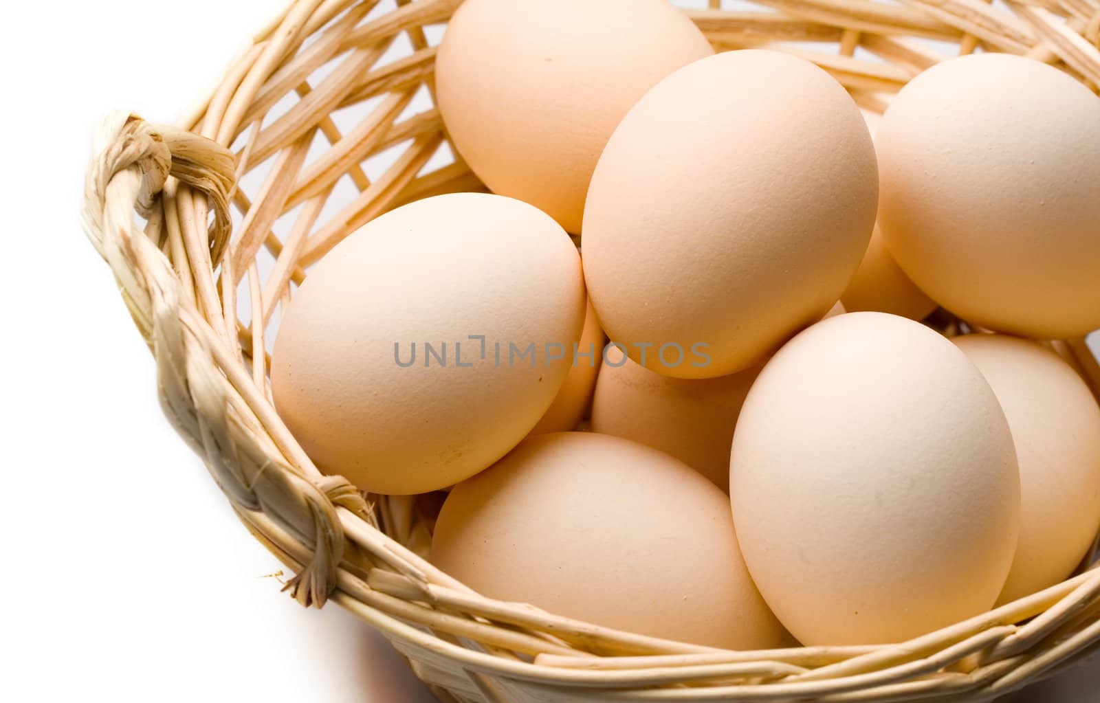 Brown eggs in the basket on white