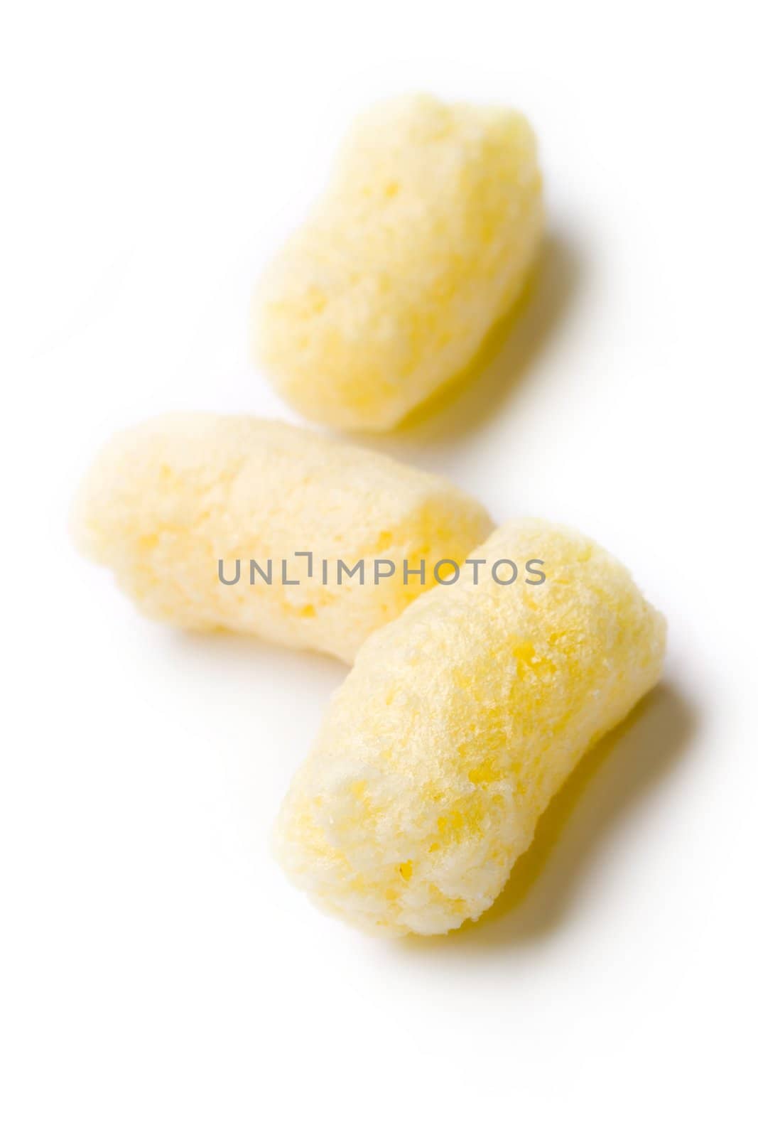 Crunchy corn snacks on white background by Garsya