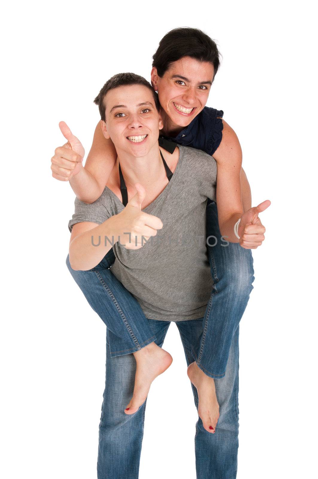 happy smiling sisters showing thumbs up sign while playing together piggyback, isolated on white background