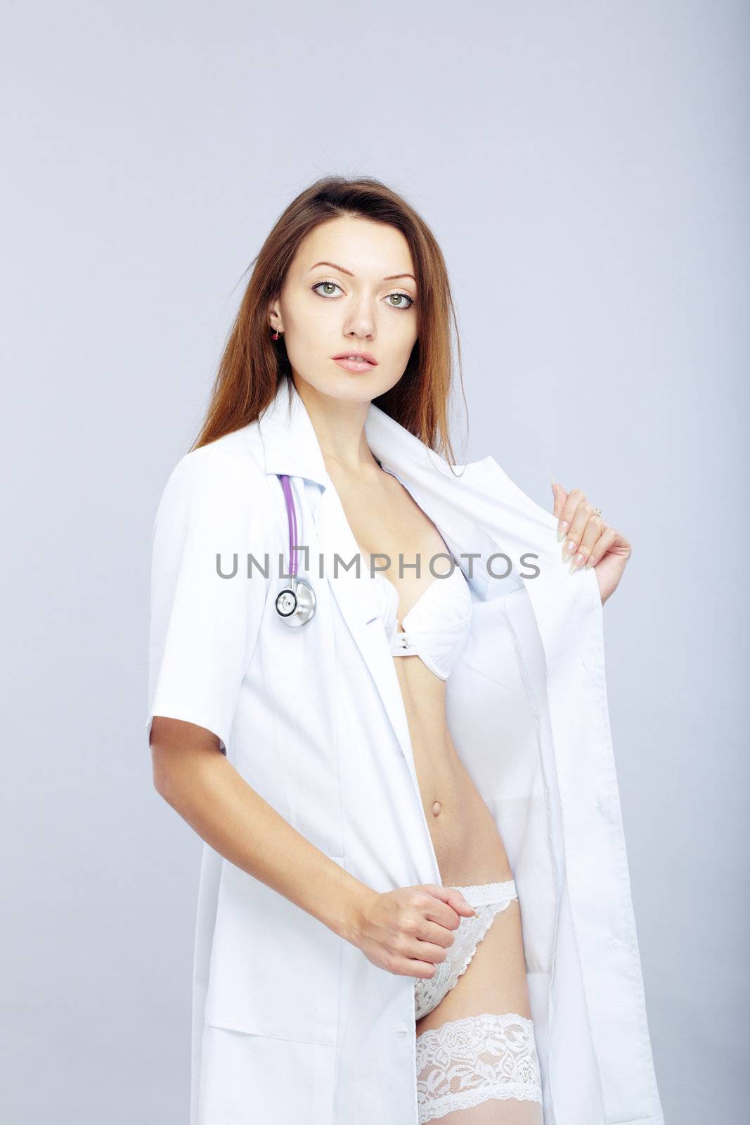 Sexy female doctor revealing medical uniform with stethoscope