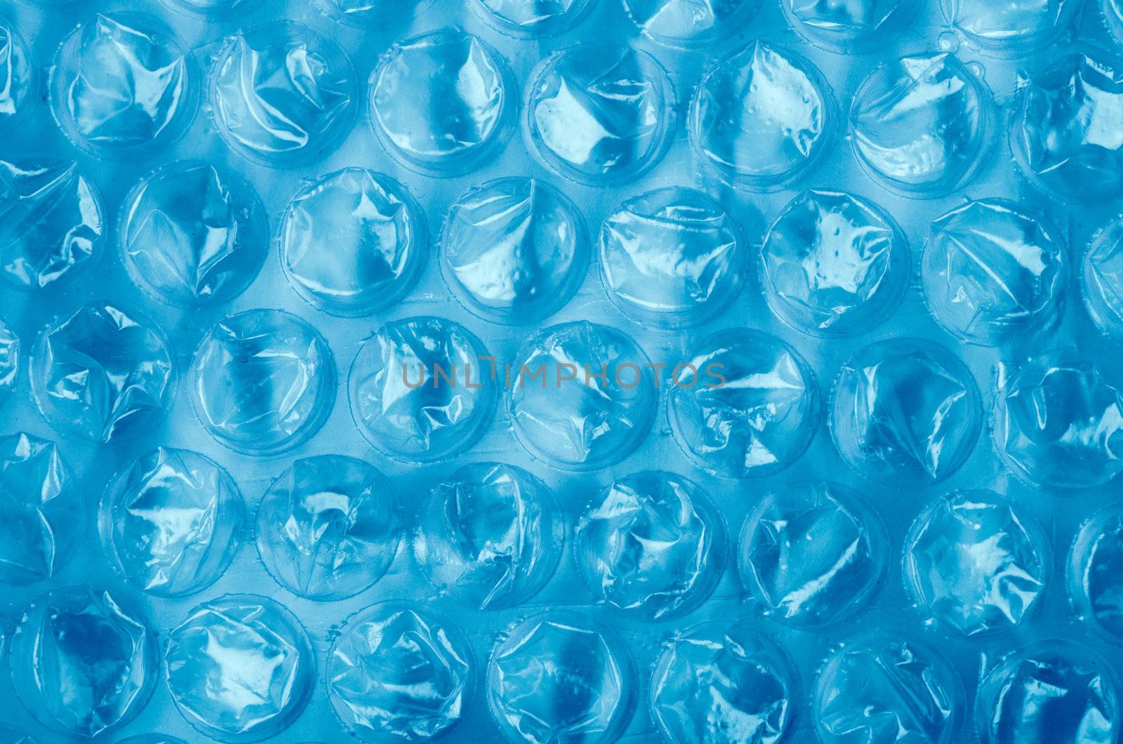 Blue Plastic bubble wrap pattern closeup.