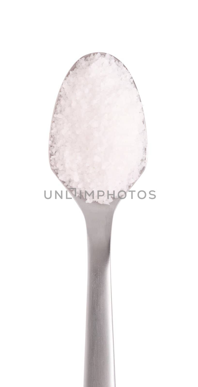 salt spice on a stainless steel spoon, isolated on white background