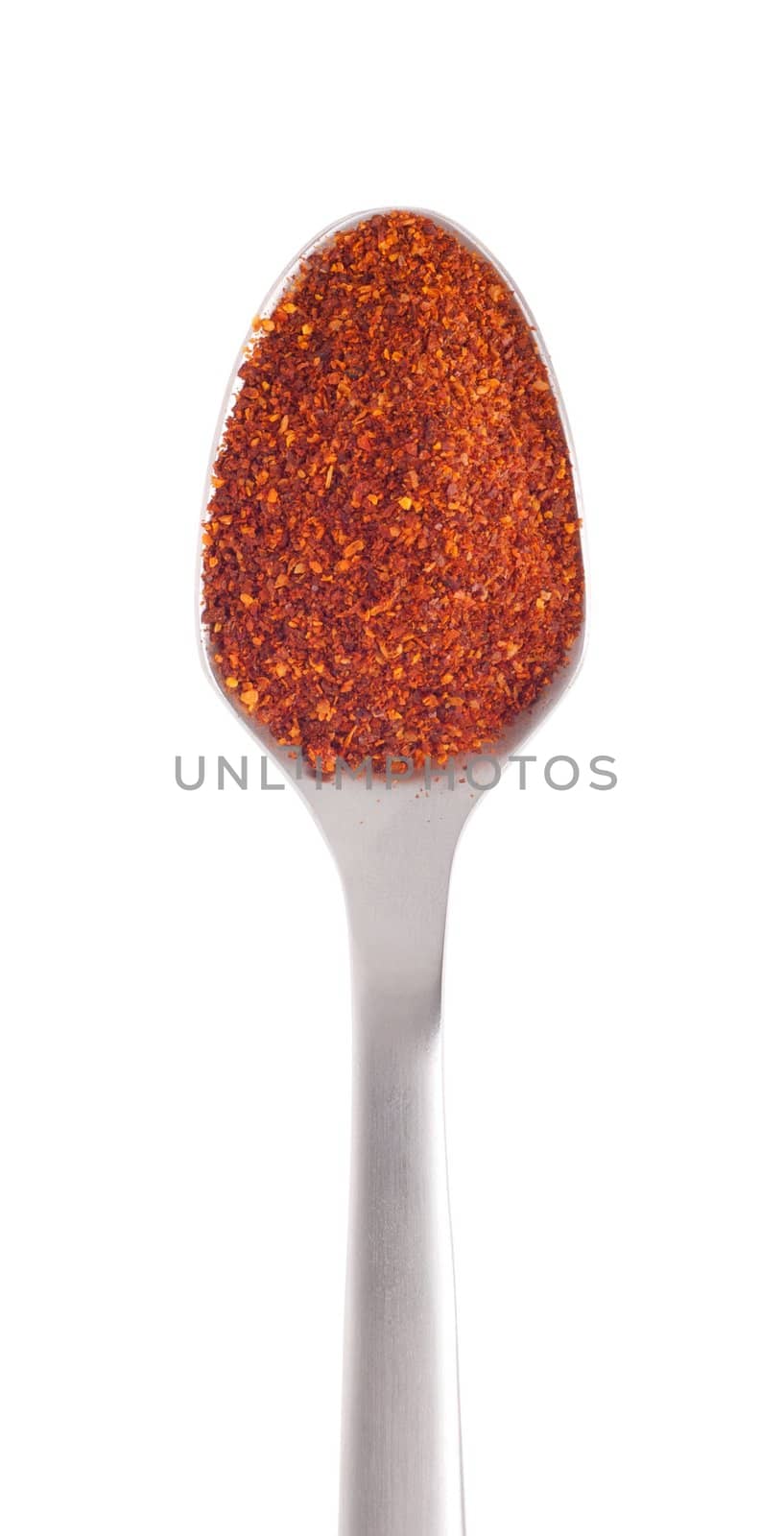 piri-piri flakes spice on a stainless steel spoon, isolated on white background