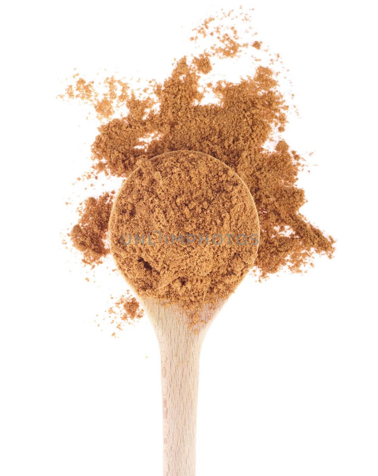 cumin spice on a wooden spoon, isolated on white background