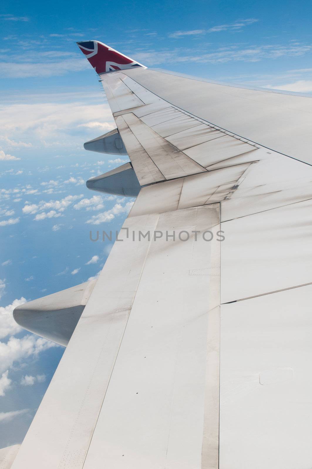 ST JOHNS, ANTIGUA - AUGUST 17: view of Boeing 747 wing of Virgin Atlantic Airways with blue sky clouds close to V. C. Bird International Airport in Antigua on August 17, 2011 in St. John's, Antigua