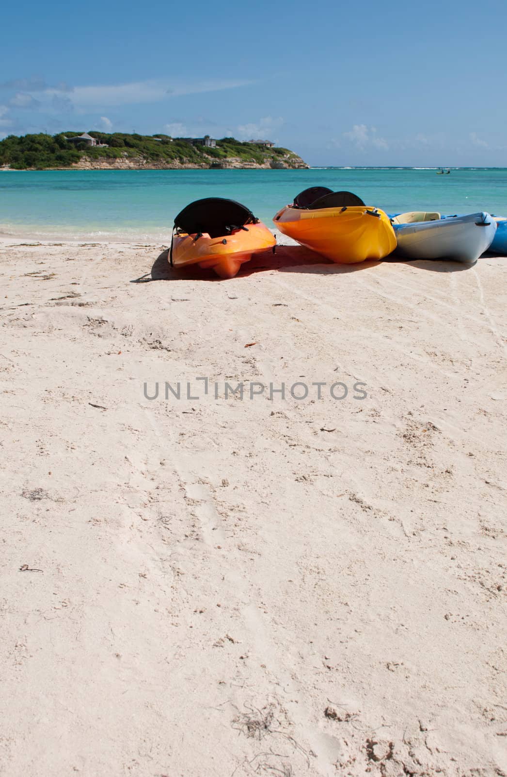 colourful kayaks on a white sandy beach, Long Bay in Antigua
