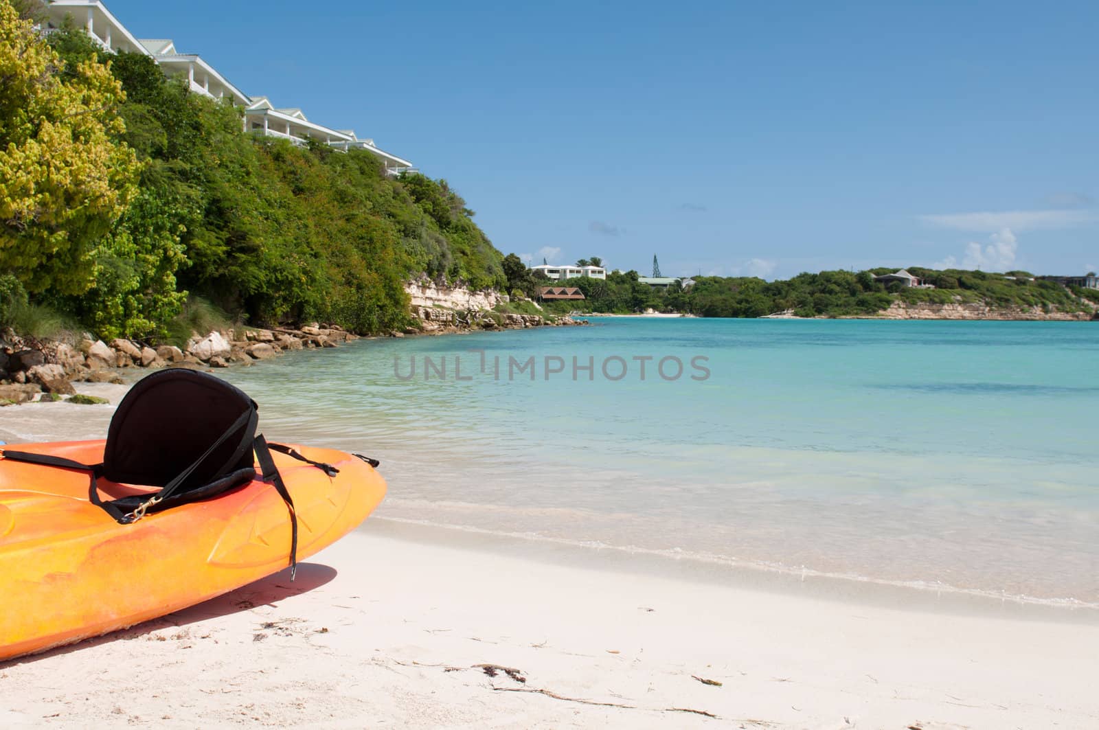 available orange kayak on a white sandy beach, Long Bay in Antigua