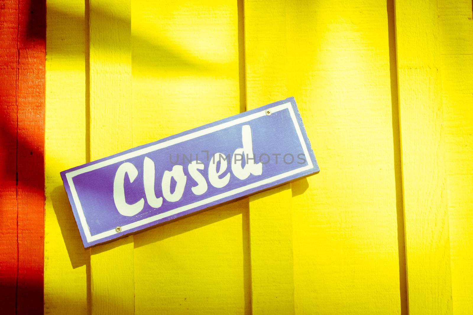 Colrful closed sign on a doorway in a tropical place