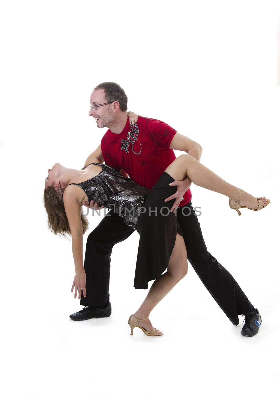 couple dancing salsa in the middle of a pose