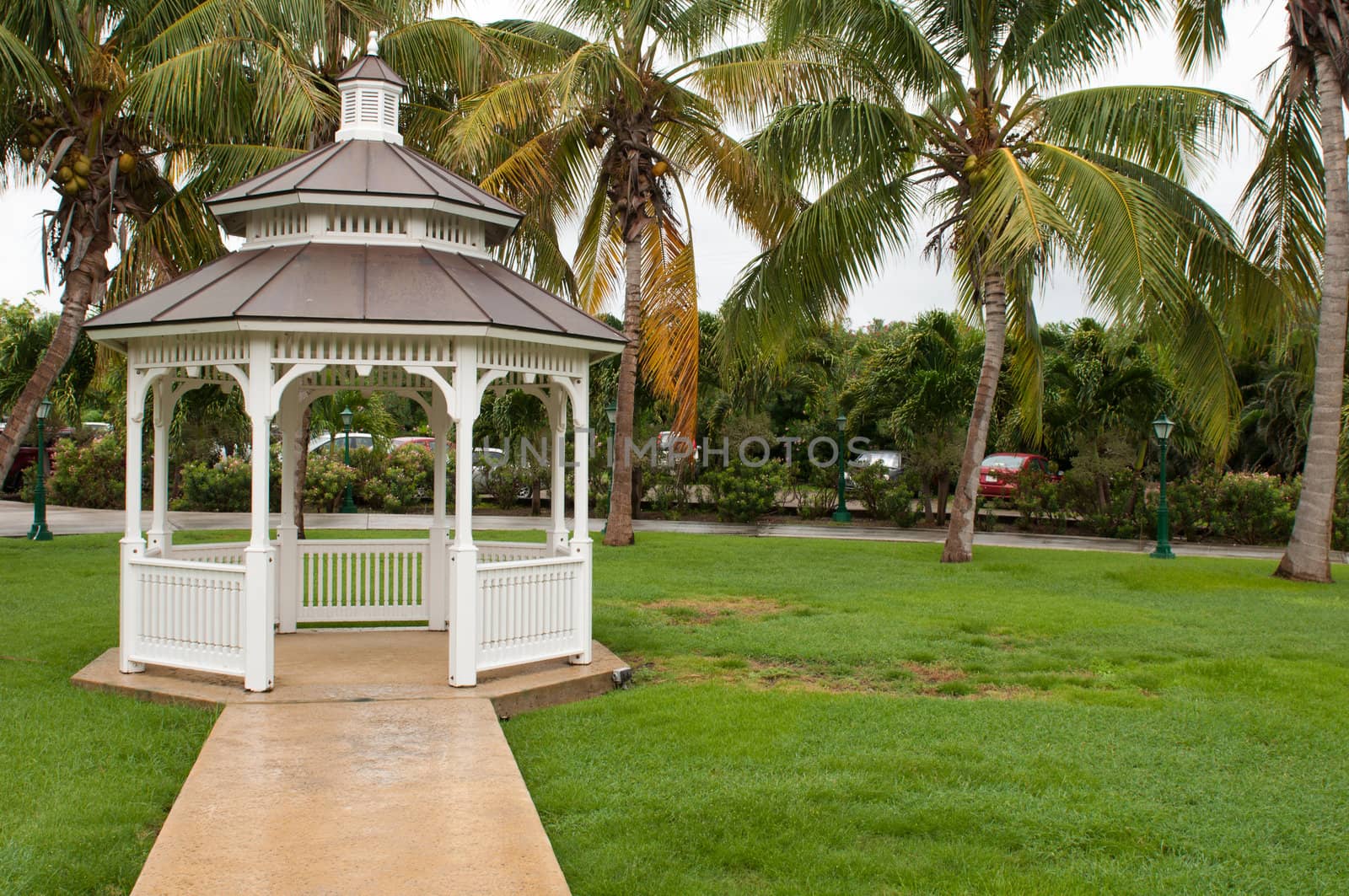pathway to grgeous white gazebo after a tropical storm (outdoor setting)