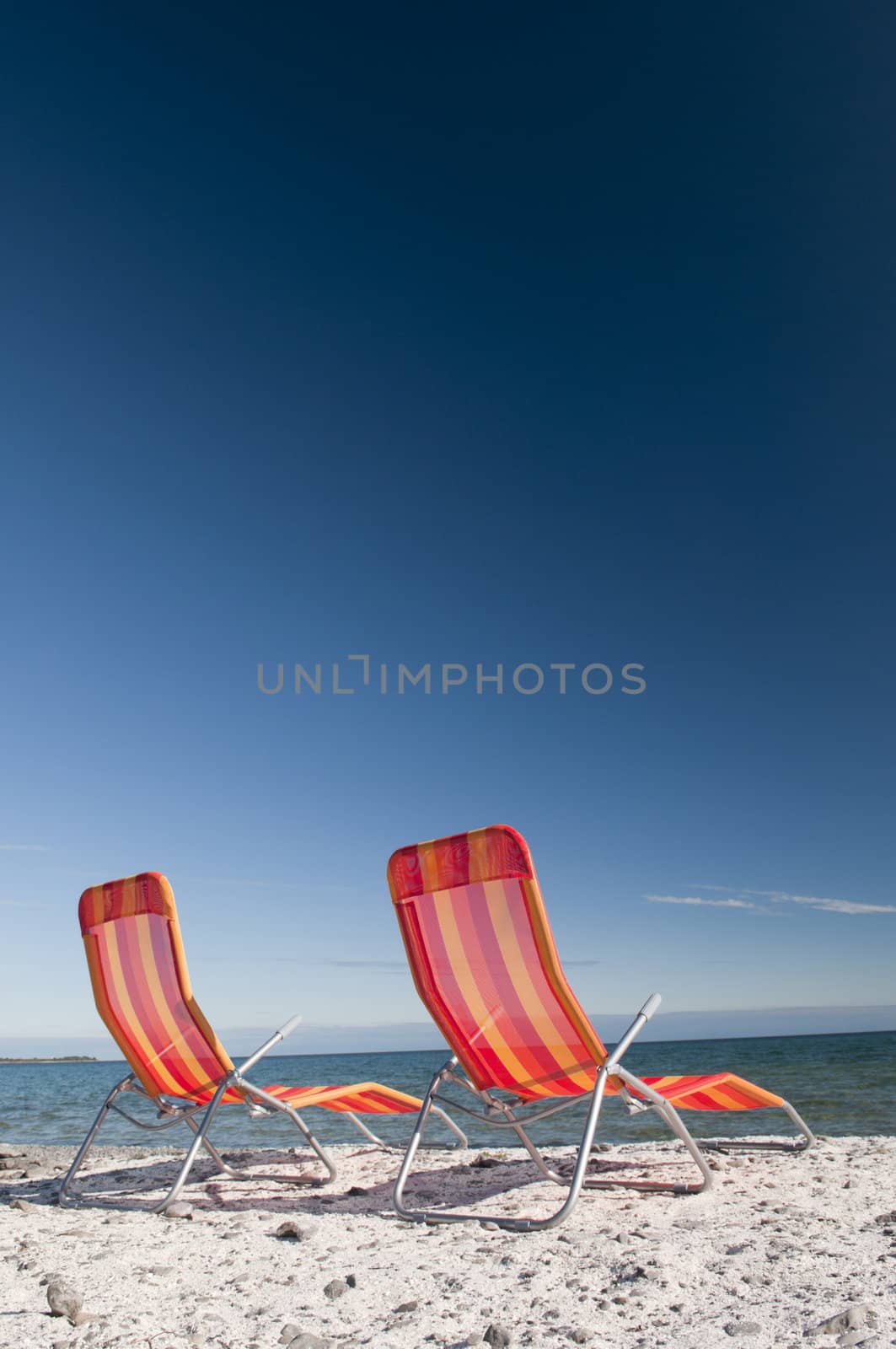 Beach Chairs on Lake Shoreline by Gordo25