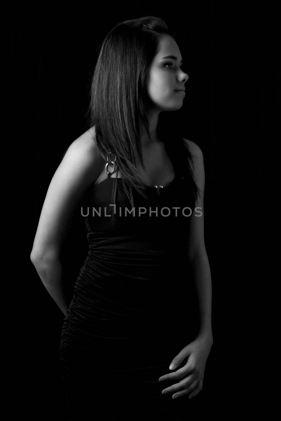 Black and white portrait of a young woman in a little black dress