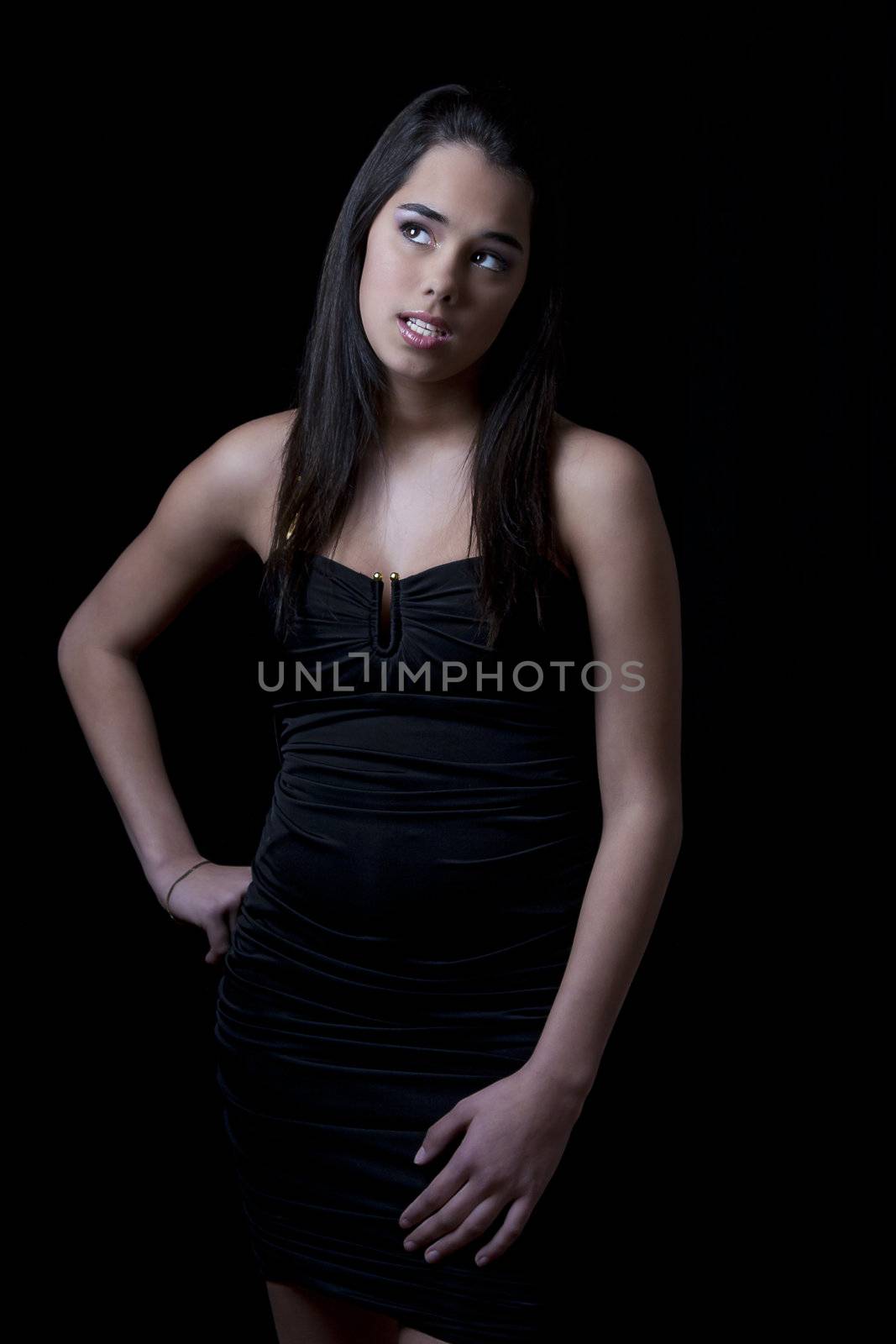 Teenage girl giving attitude and looking up in a little black dress