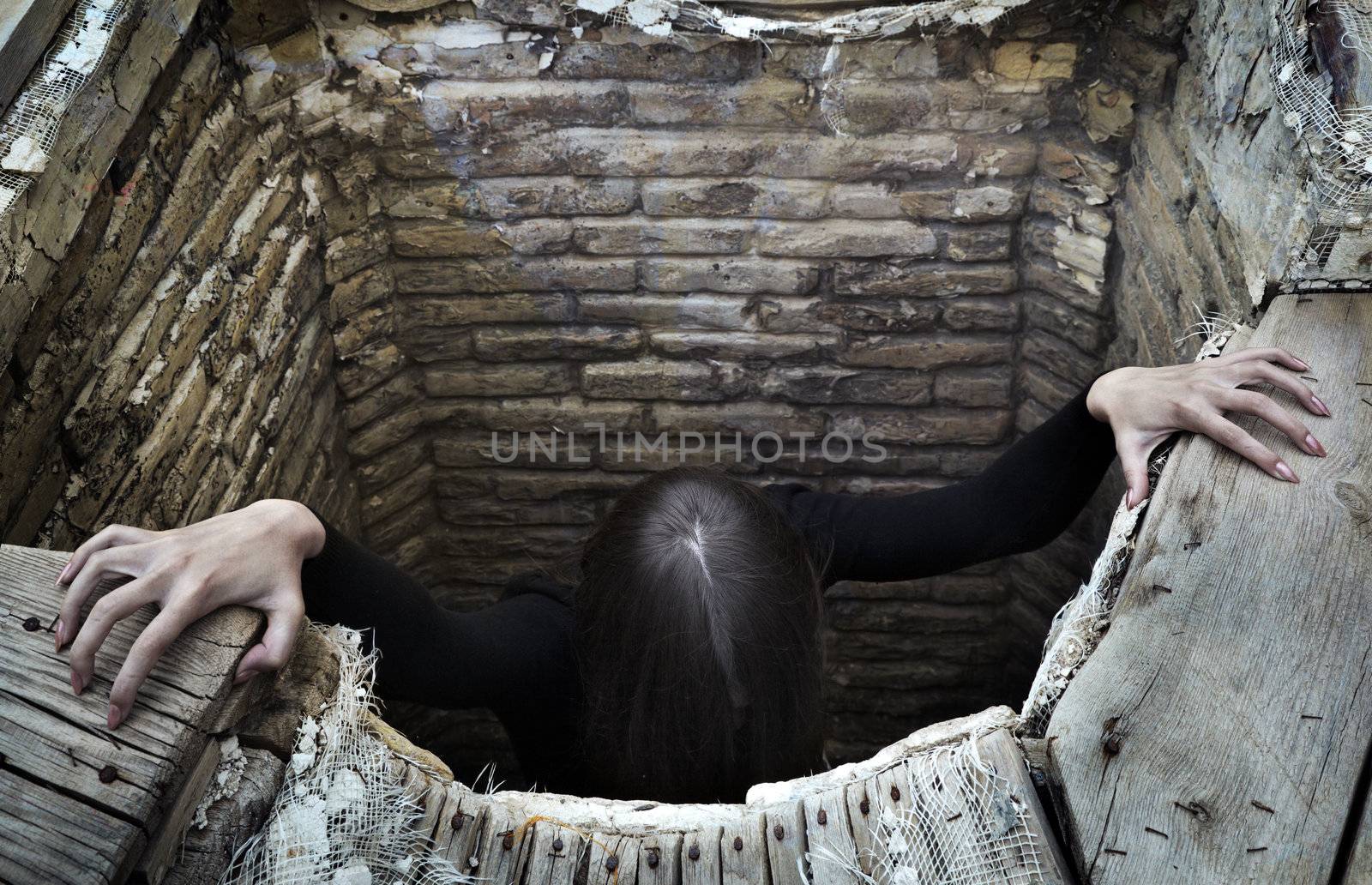 Terrible woman getting out the well