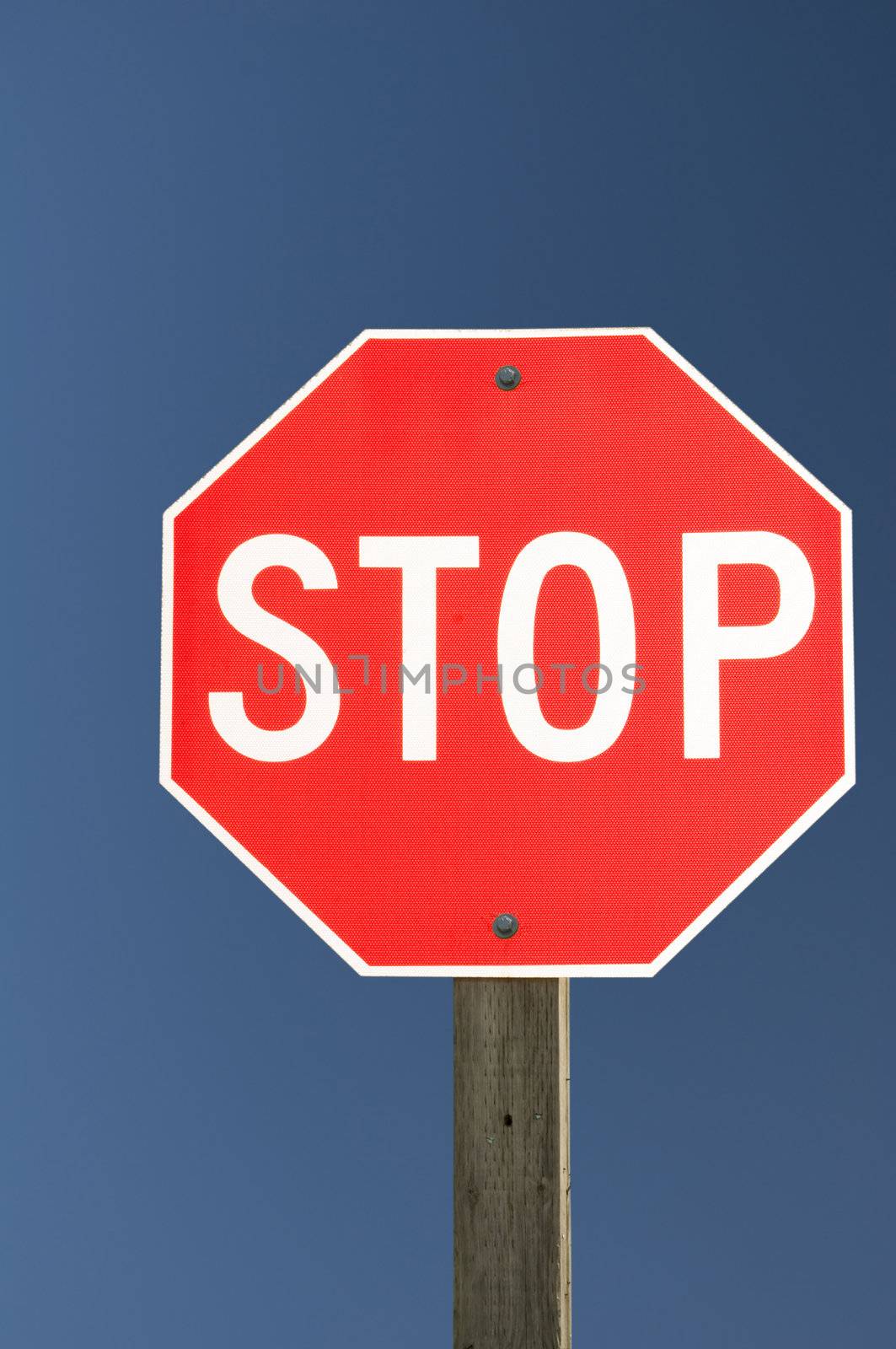 Focus on a Stop Sign on a deep blue sky