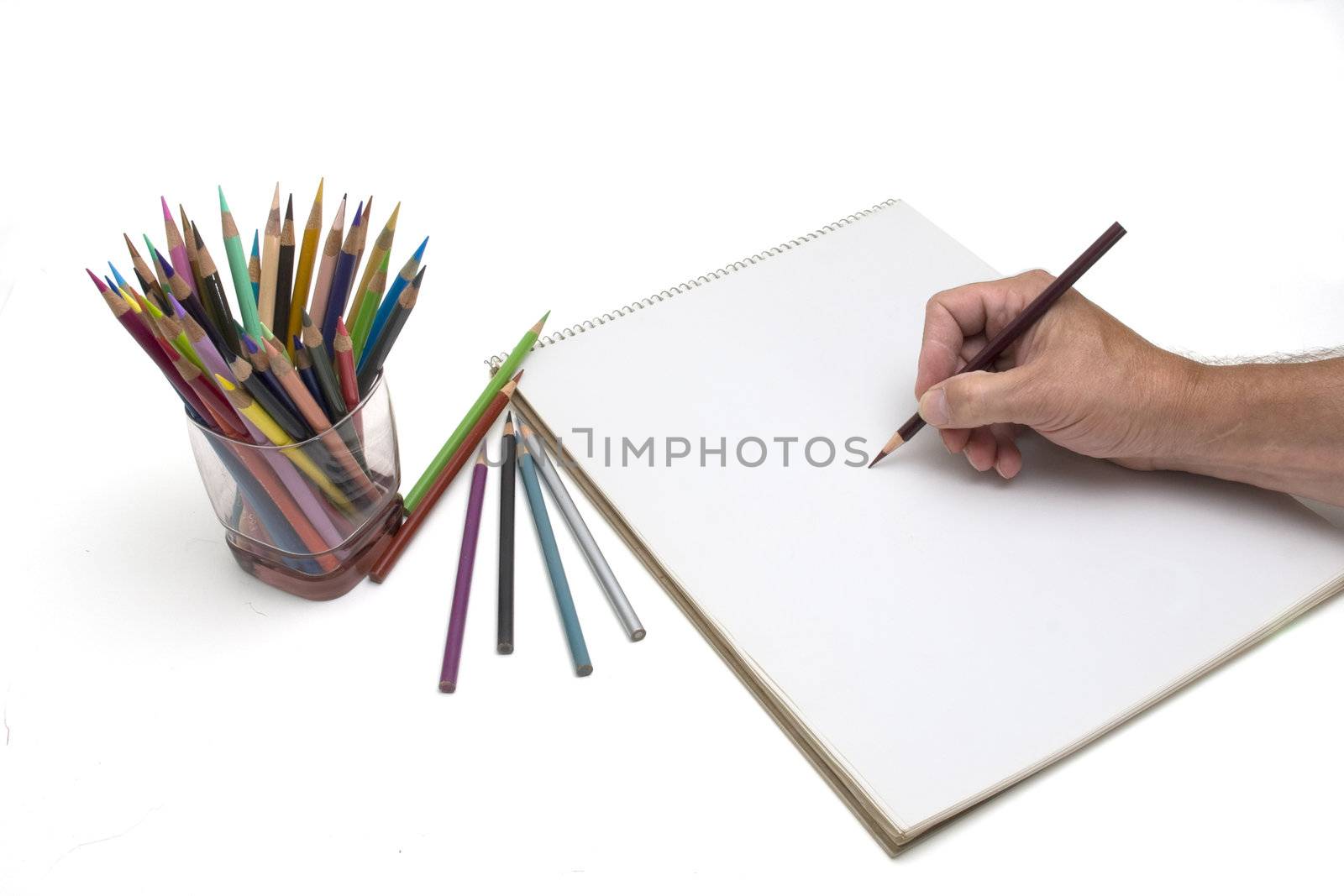 Artist starting a drawing using colored pencils.