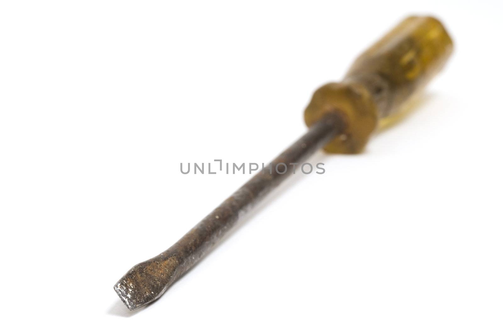 Selective focus on the end of an old screwdriver isolated on a white background