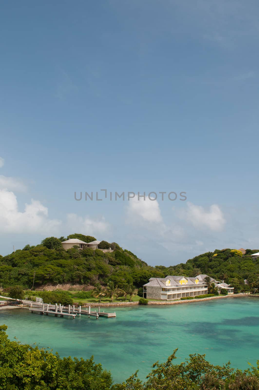 Antigua Long Bay, gorgeous seascape view surrounded by tropical nature and some typical houses