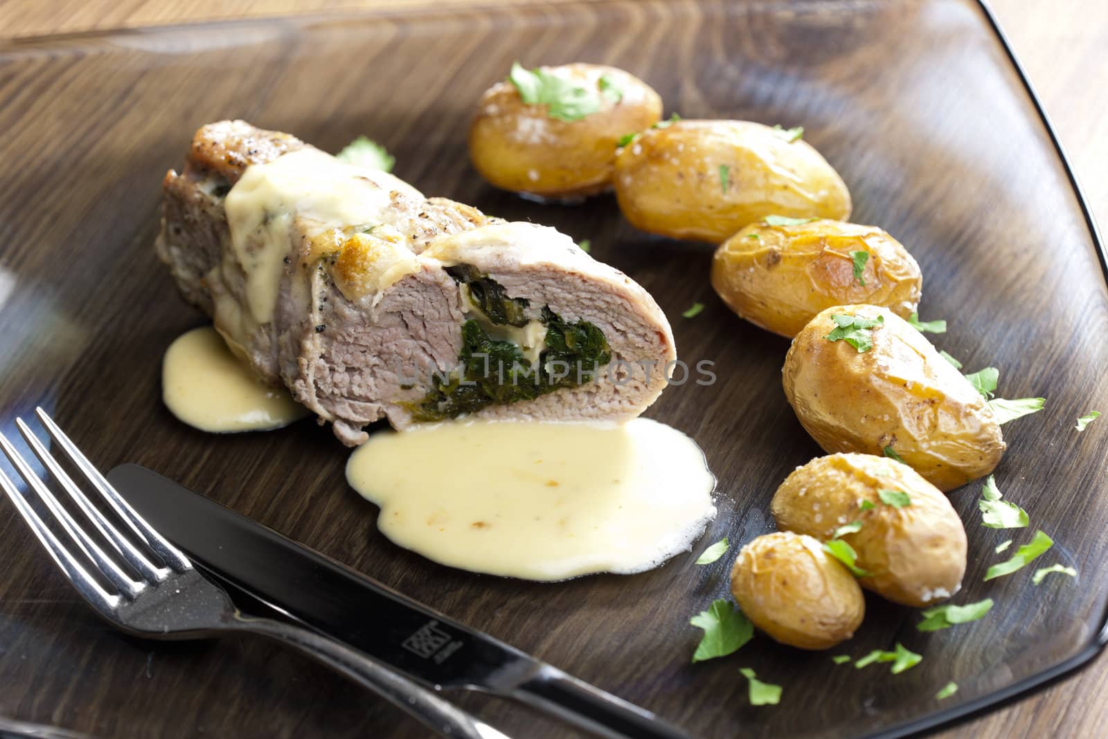baked pork tenderloin filled with spinach and goat cheese on cream