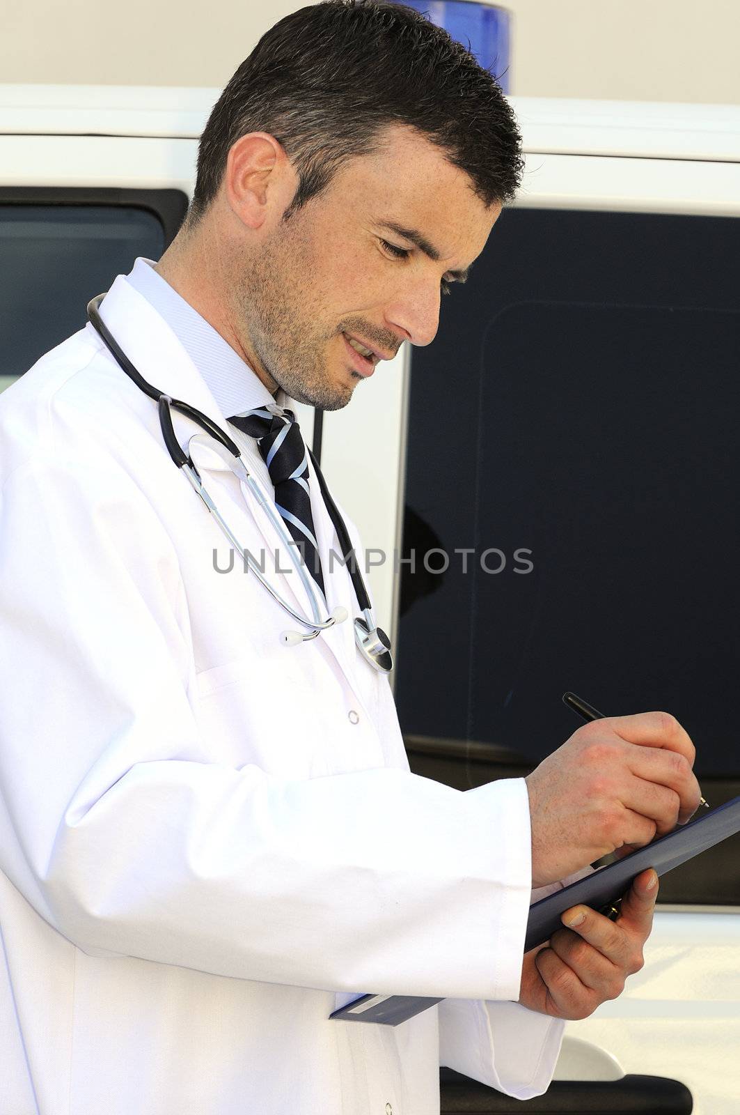 doctor is writing a report behind an ambulance