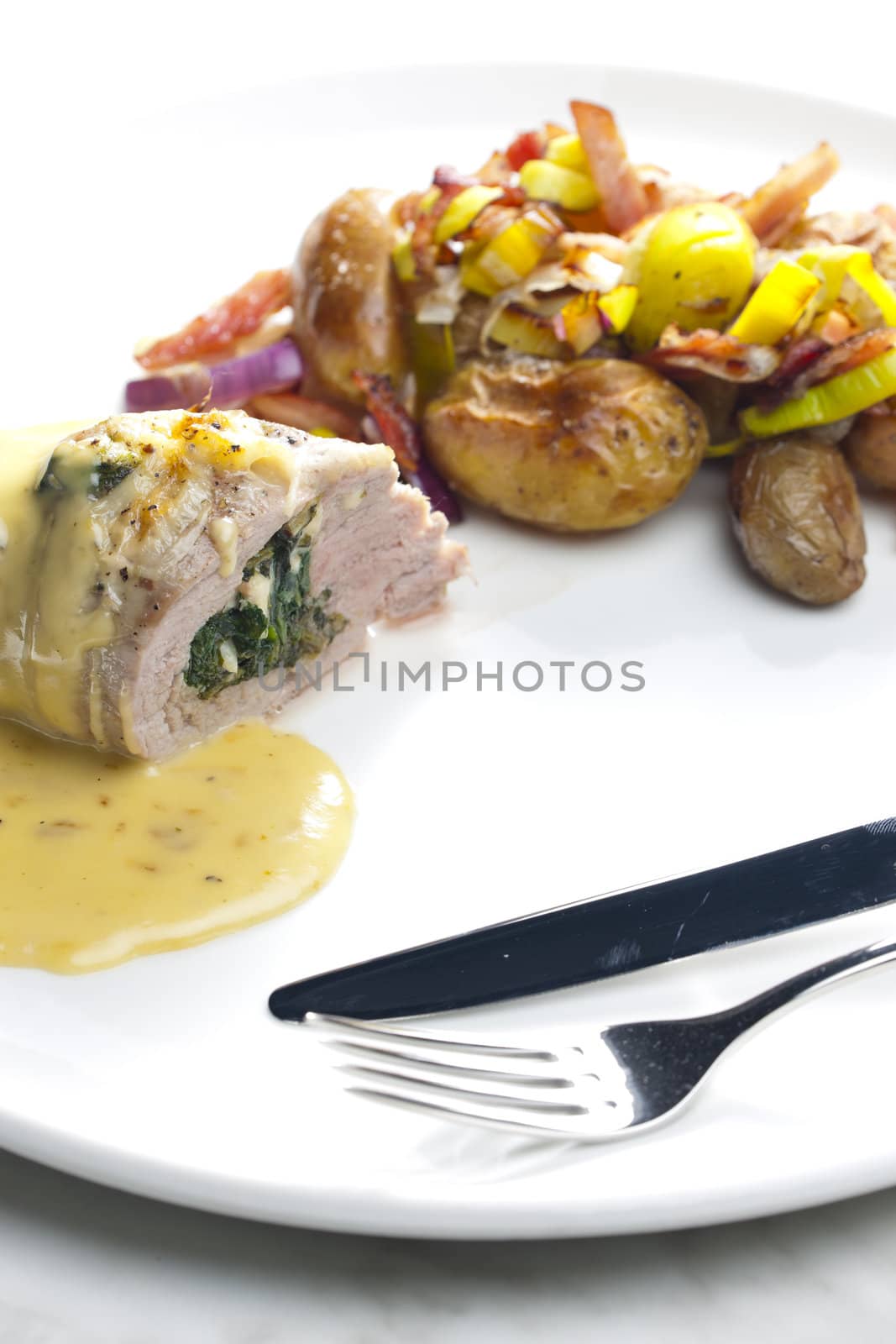 baked pork tenderloin filled with spinach and goat cheese on cream