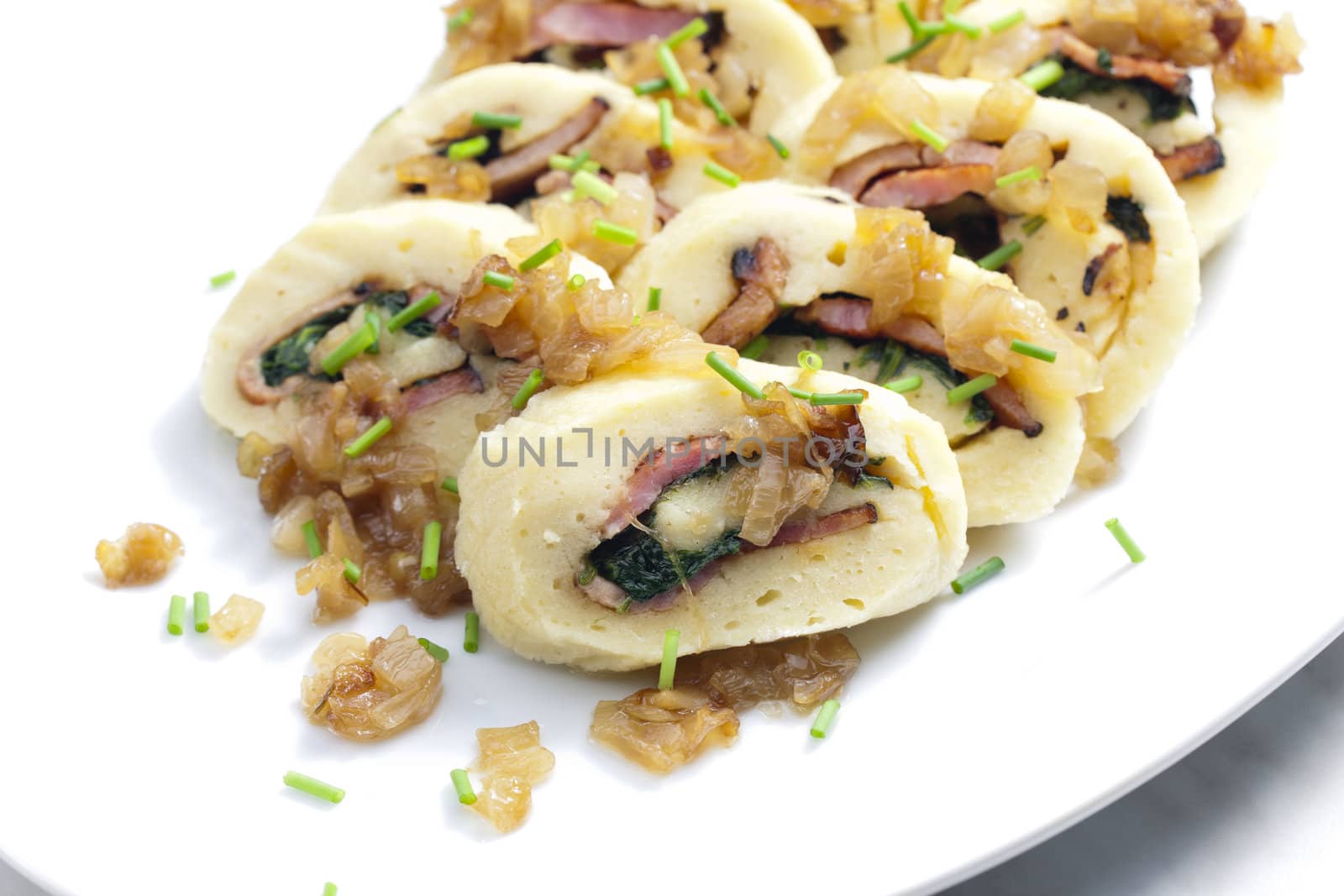 roll from potato dough filled with spinach and bacon