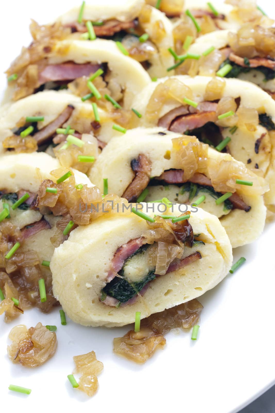 roll from potato dough filled with spinach and bacon