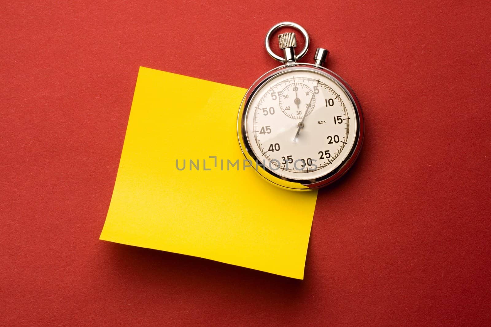 Stopwatch and label isolated on red