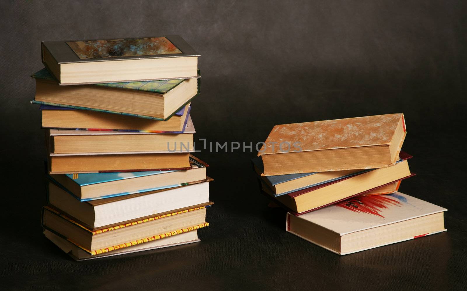 Two piles of books in different bindings in studio