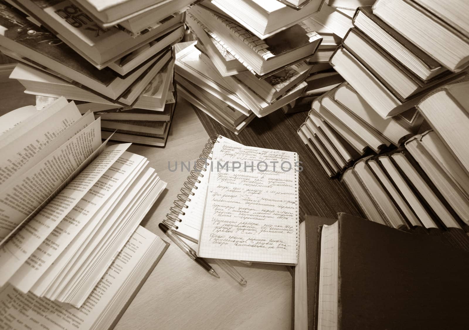 Many old books combined by a heap. Russian saying 'Knowledge - light, ignorance - darkness'