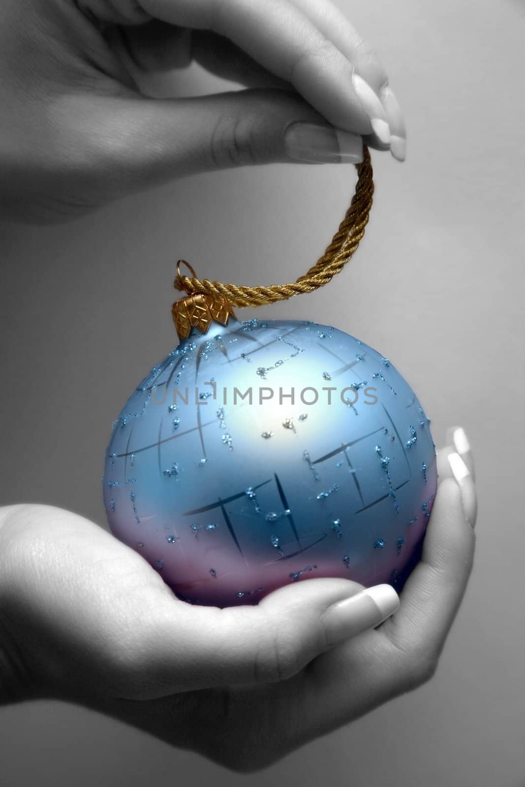 Blue sphere in female hands. Partial decolouration