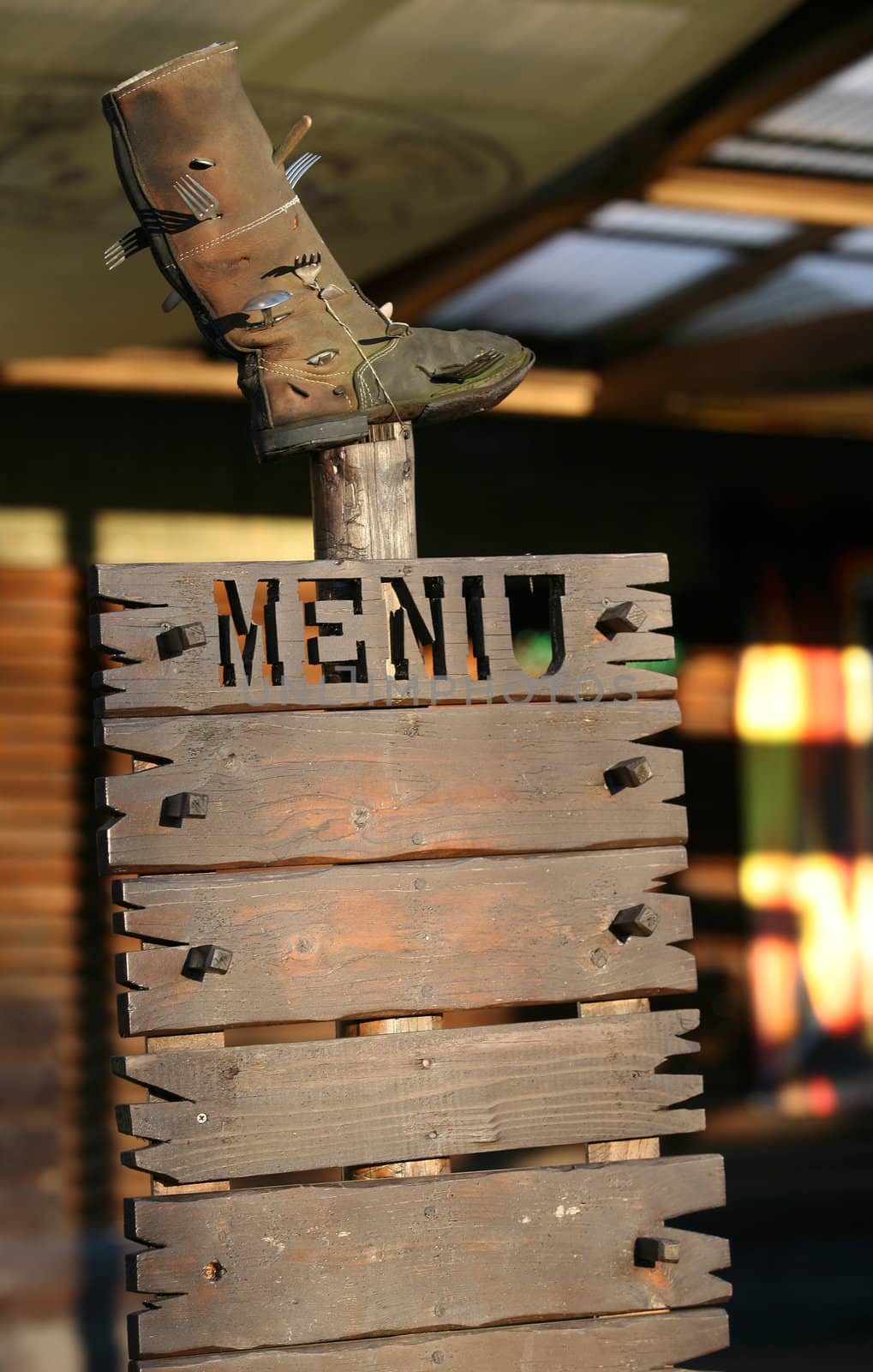 The wooden menu with old a boot above