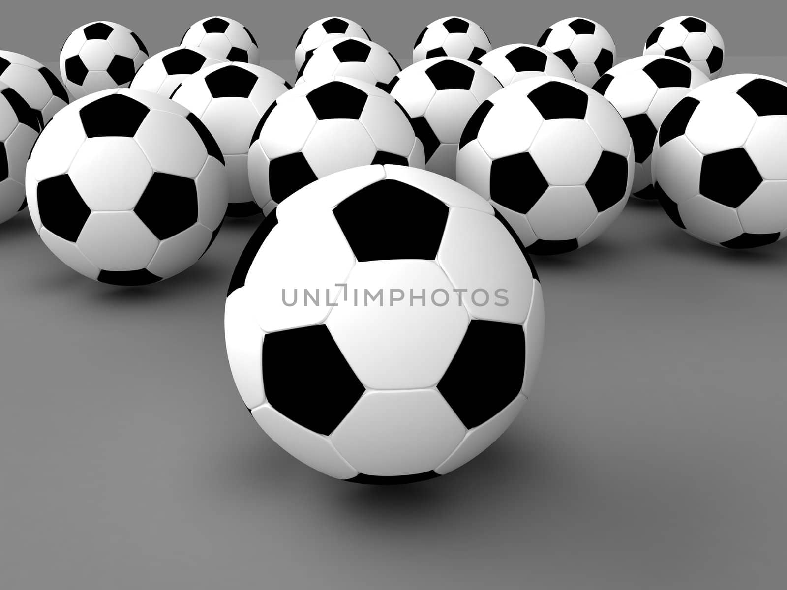 Some footballs on a grey background