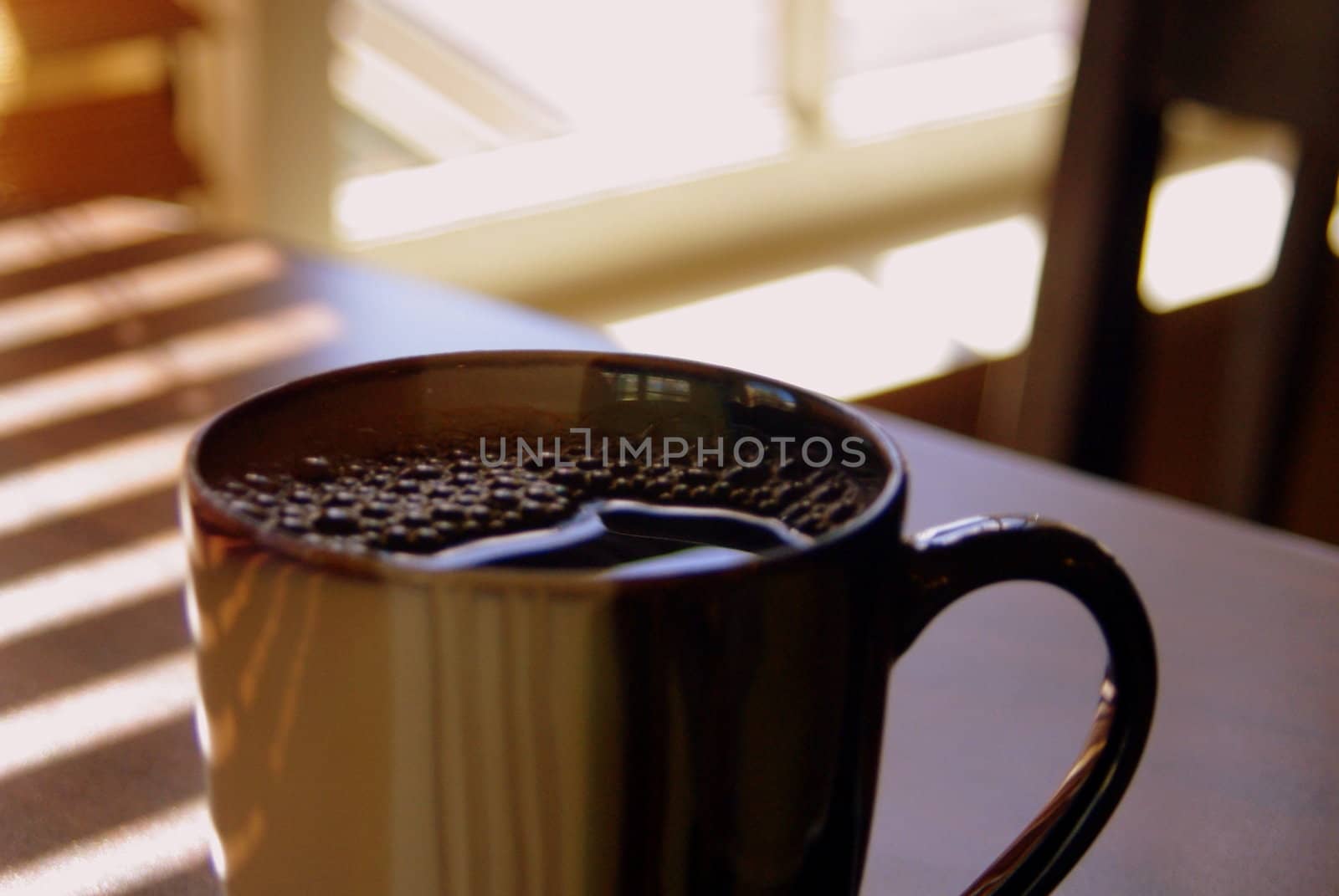 Cup of coffee in sunny window