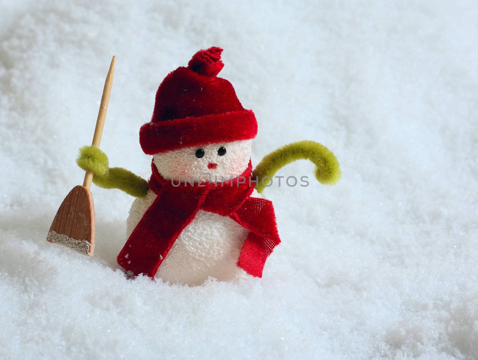 Toy of the snowman in snow