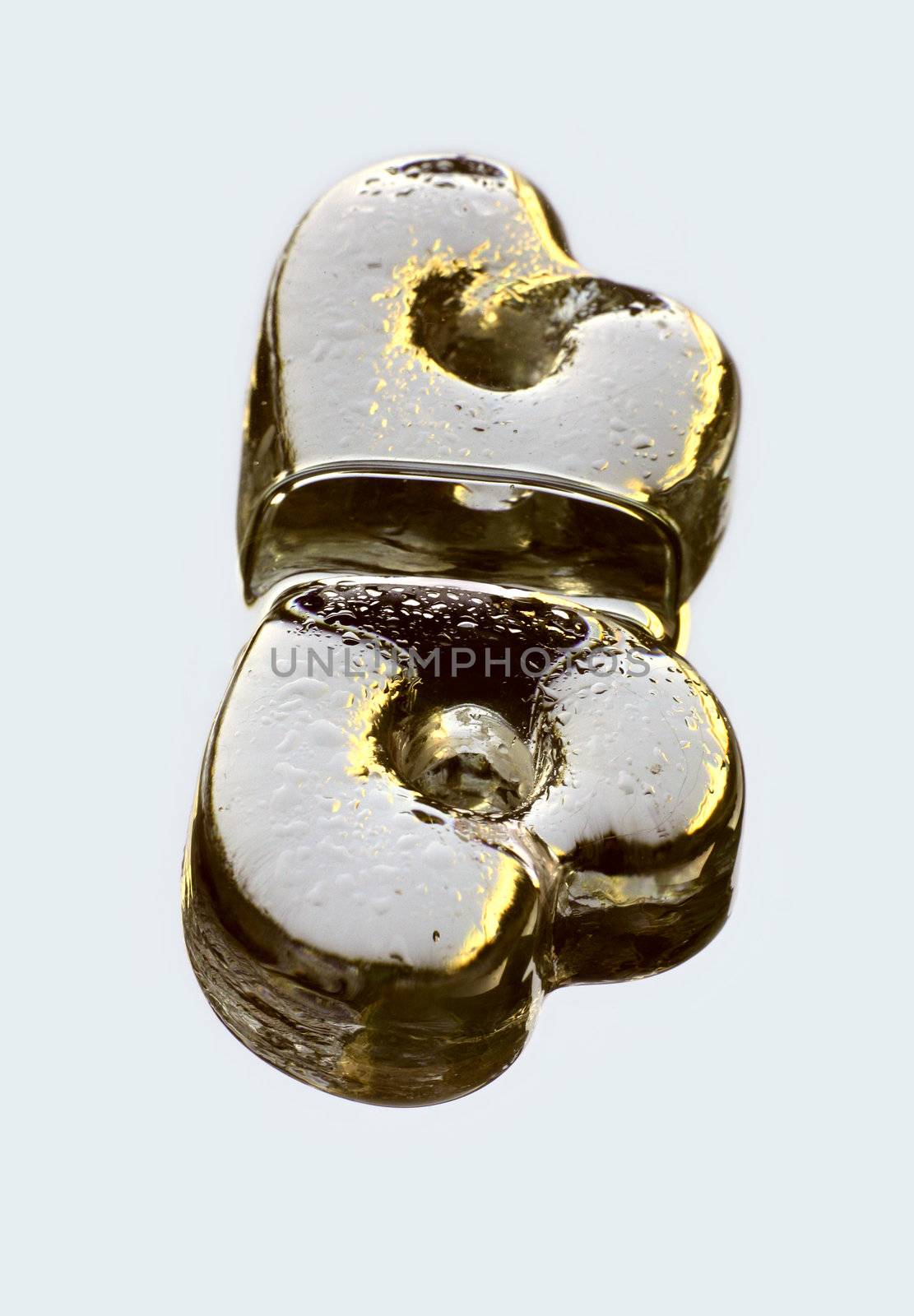 The image of glass heart with reflection in a smooth surface