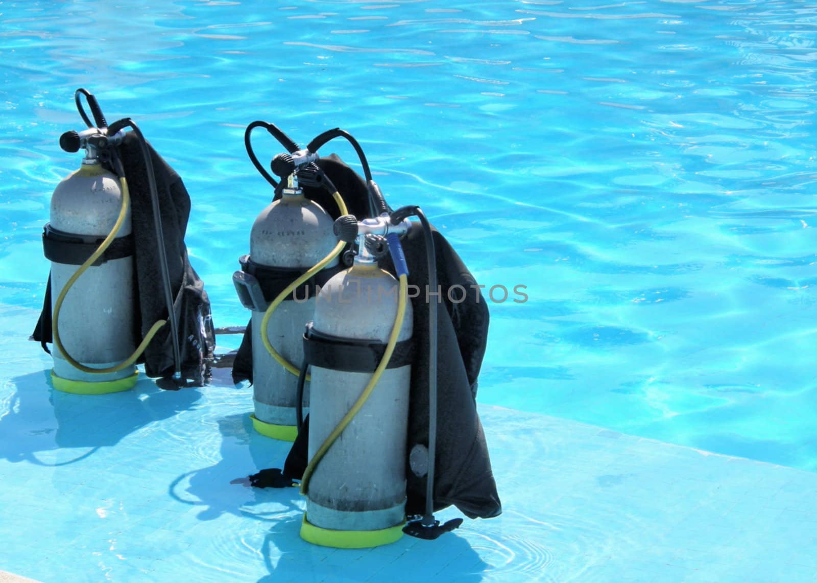 three oxygen tanks ready for scuba diving