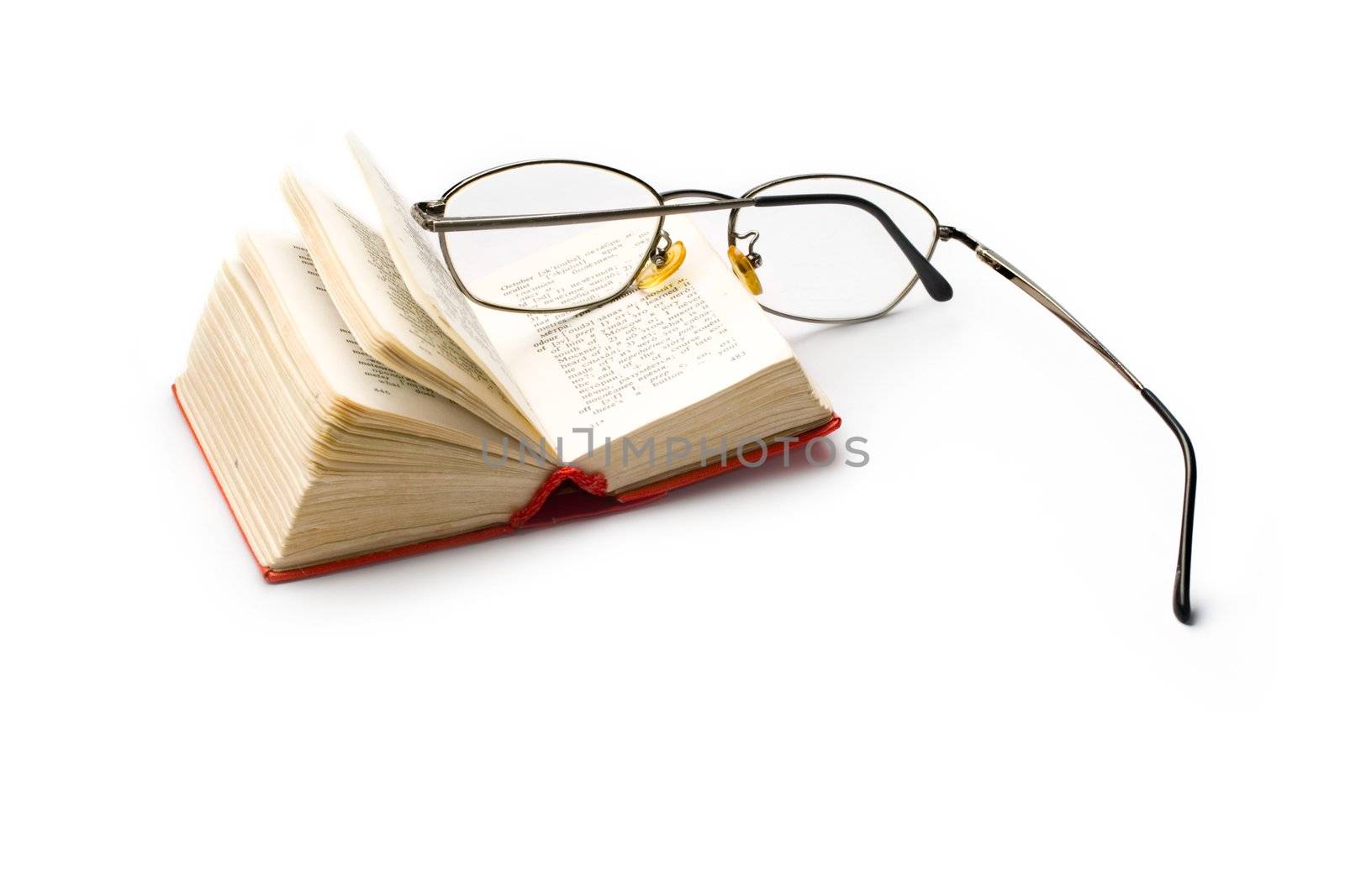 Book and glasses isolated on white