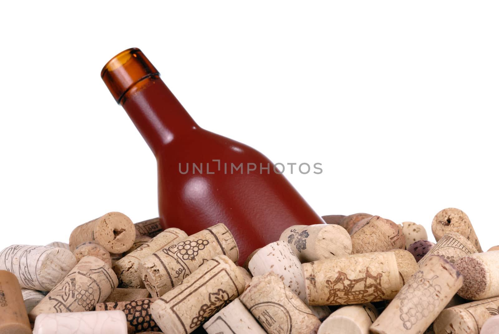 Wine bottle and a lot of wine-corks isolated on white