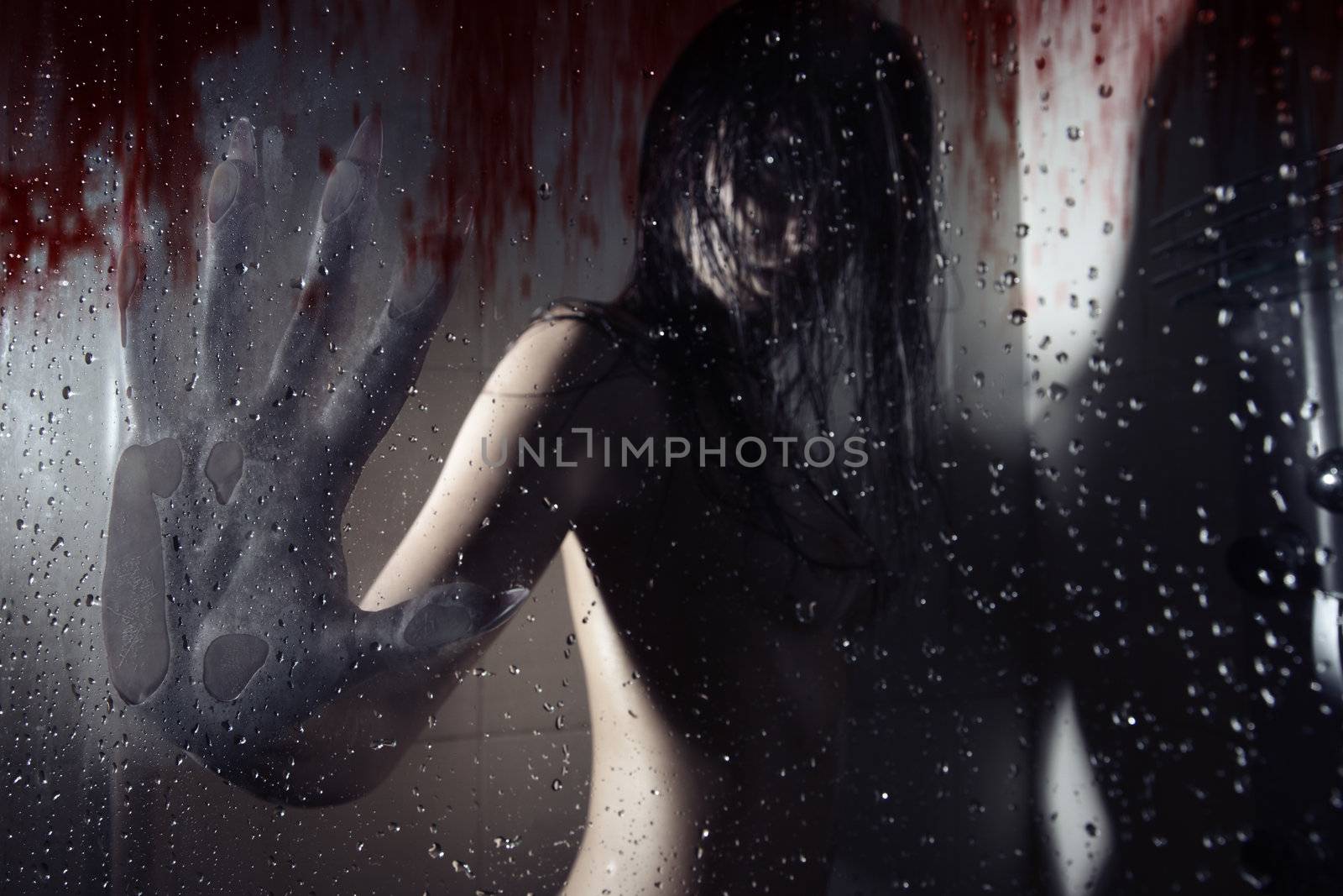 Werewolf in the dark bathroom touching wet bloody glass