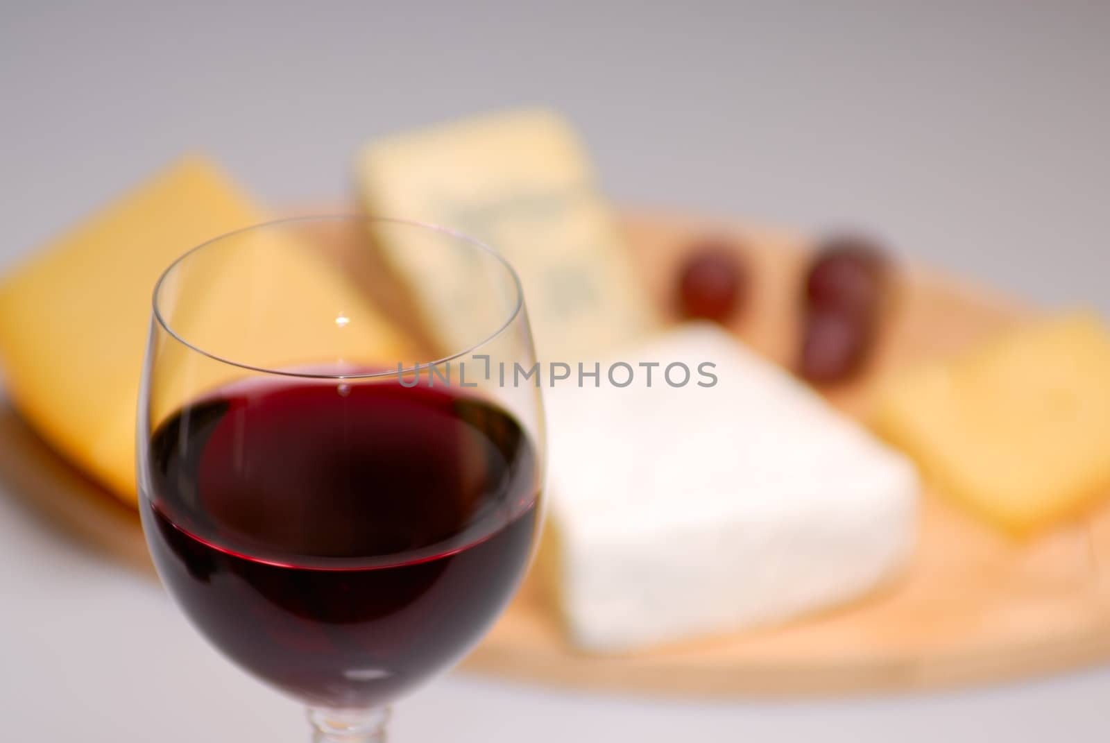 Glass of red wine and cheese plate