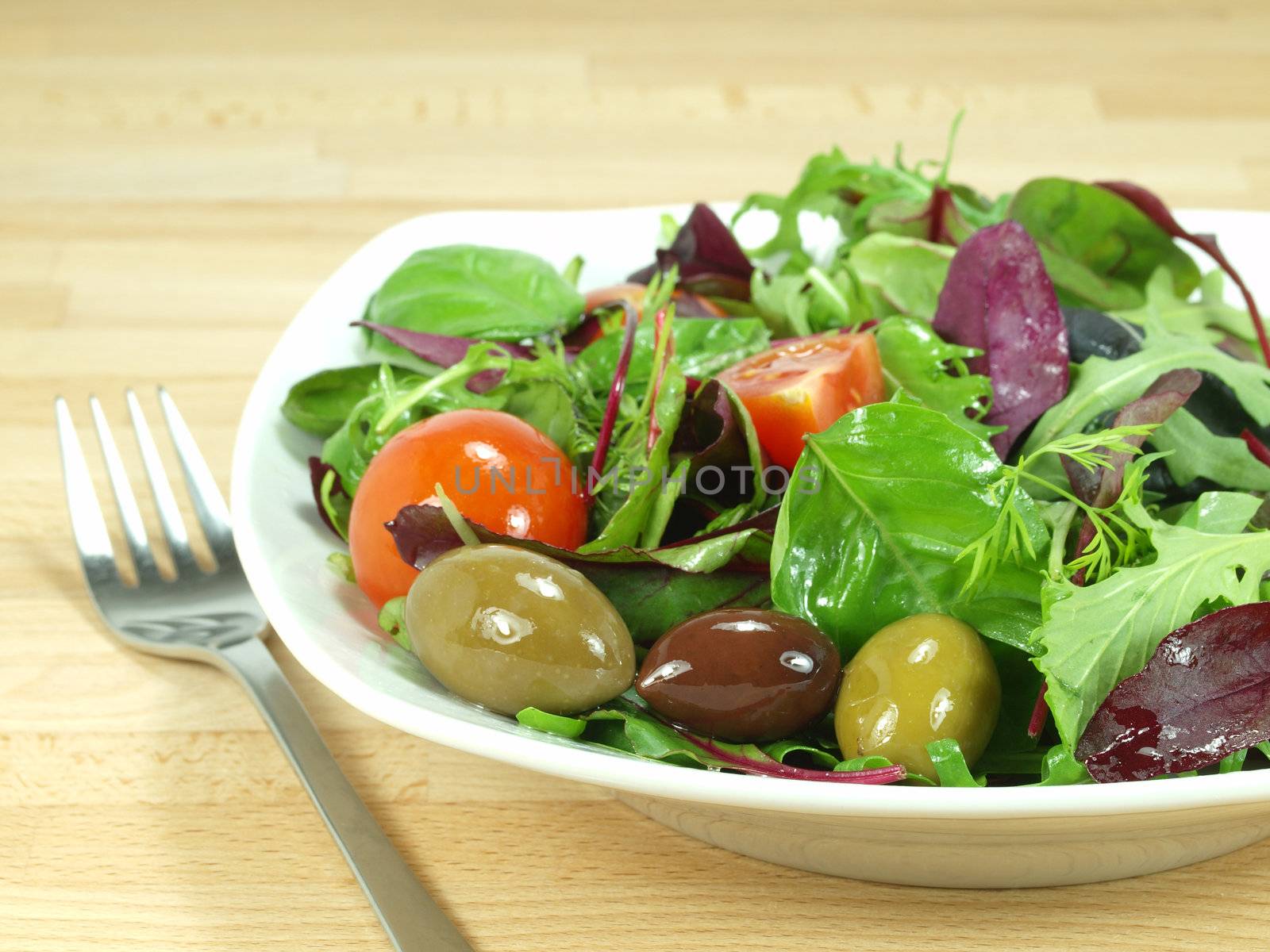 mixed baby green salad dressed with olive oil     