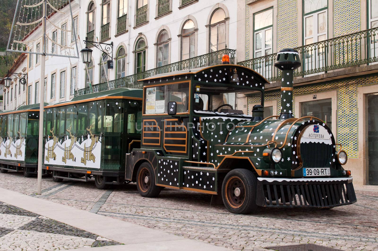 TOMAR, PORTUGAL - DECEMBER 15: sightseeing car train waiting for tourists on Republica Square on December 15, 2011 in Tomar, Portugal. One of the most famous square in Tomar where is the Gualdim Pais statue, founder of the city