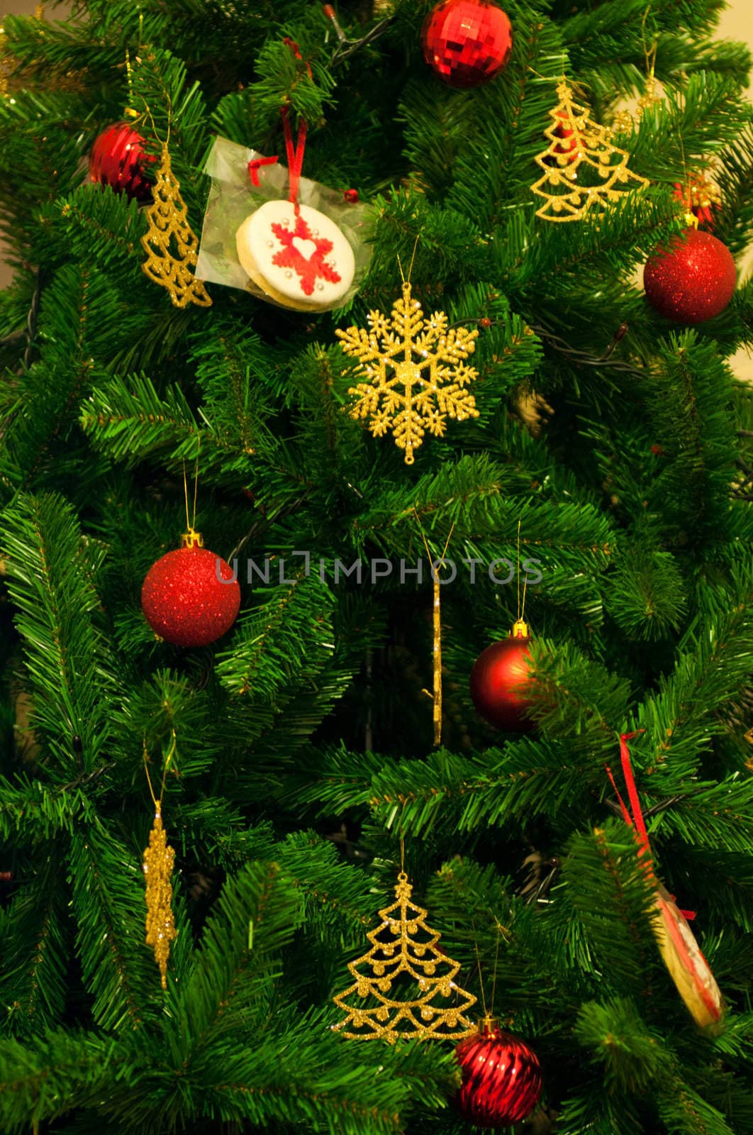 decorated christmas tree with red bauble and golden trees and stars (background picture)