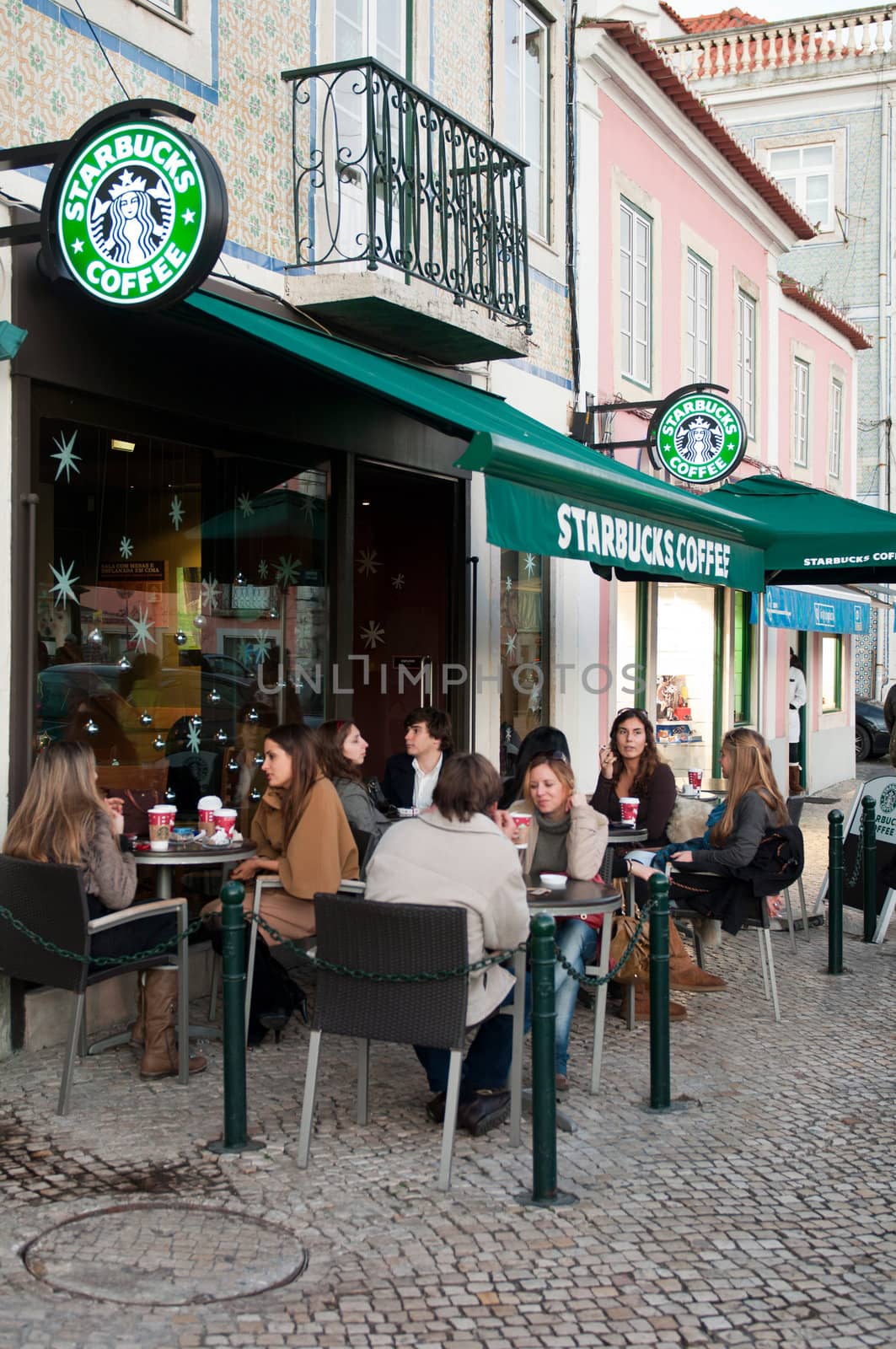 LISBON, PORTUGAL - DECEMBER 19: people having a break at Starbucks coffee esplanade on December 19, 2011 in Lisbon, Portugal. Starbucks is the largest coffeehouse company in the world with 18,887 stores