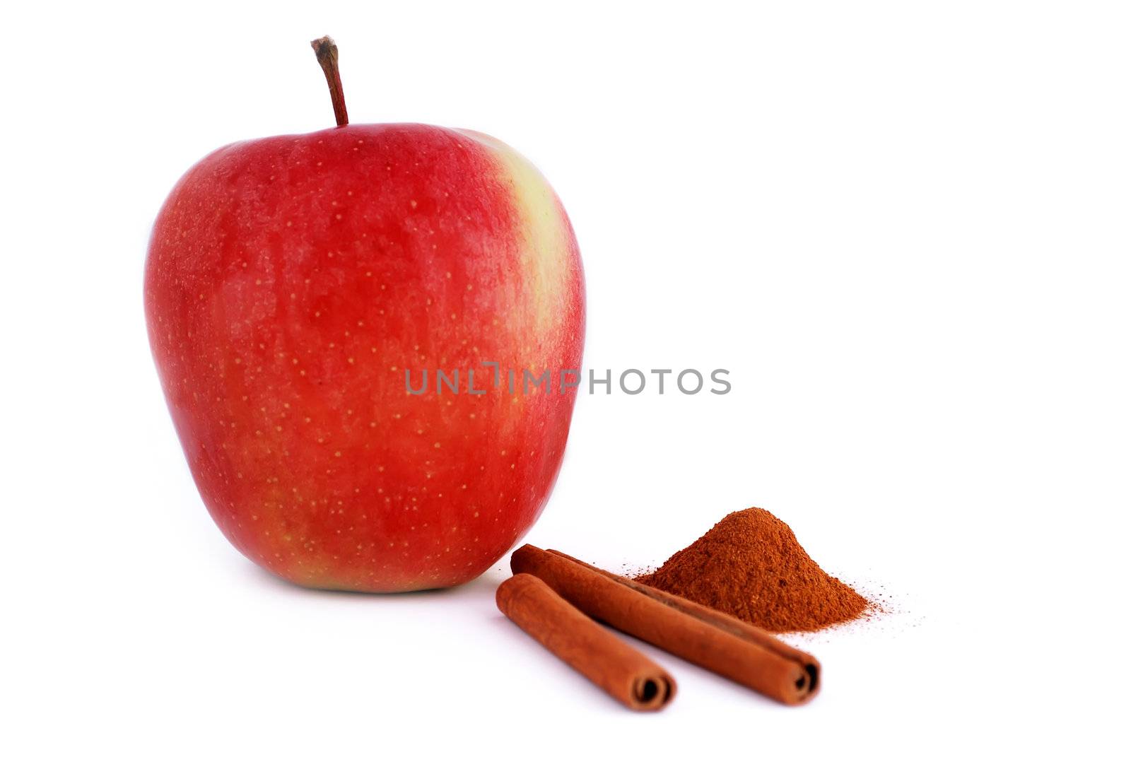 red apple with cinnamon on a white background