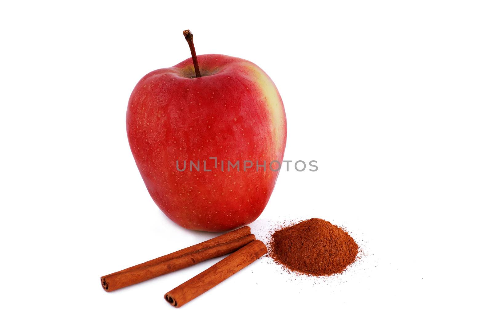 red apple with cinnamon on a white background