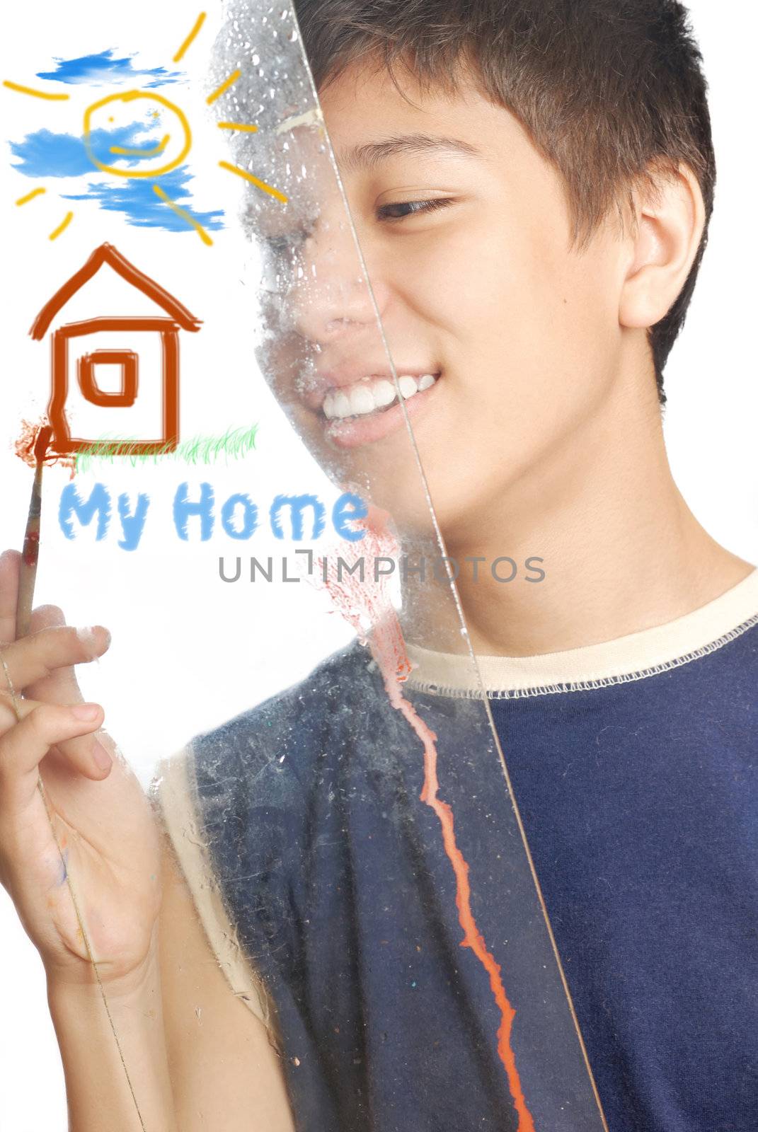 Boy drawing home and sun as a symbols of the family