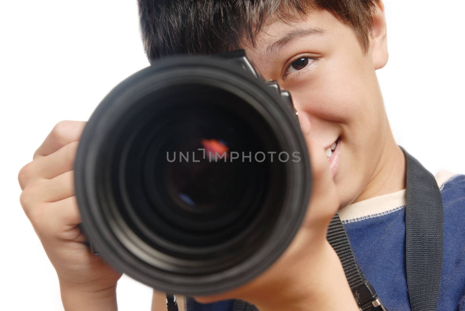 Photo of  smiling boy with digital camera and big lens